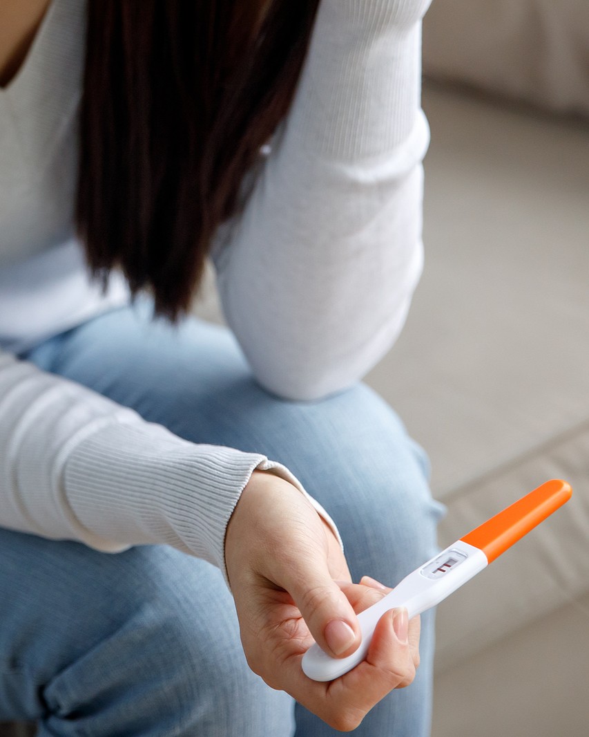Confirm Your Pregnancy at CAPS Woman holding a free pregnancy test
