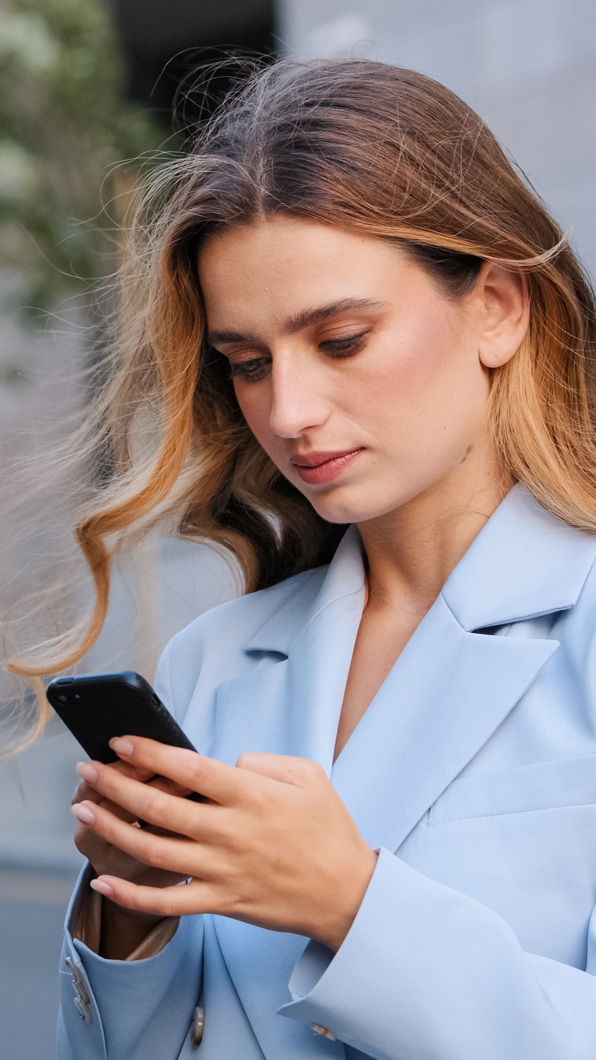 What Does an Abortion Cost A woman researching on her phone "What Does an Abortion Cost?"