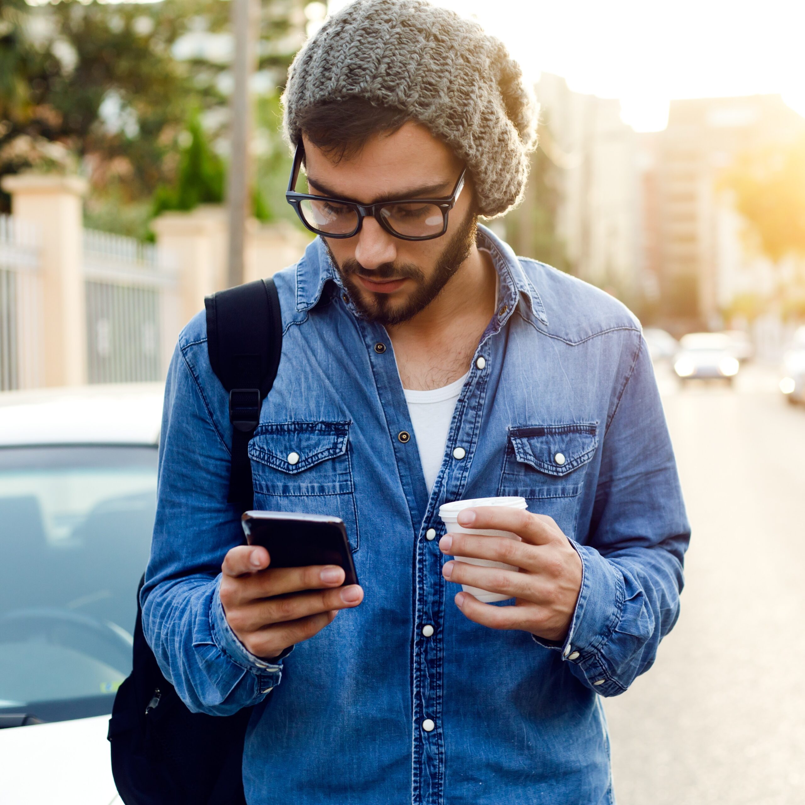 Modern Young Man With Mobile Phone In The Street.
