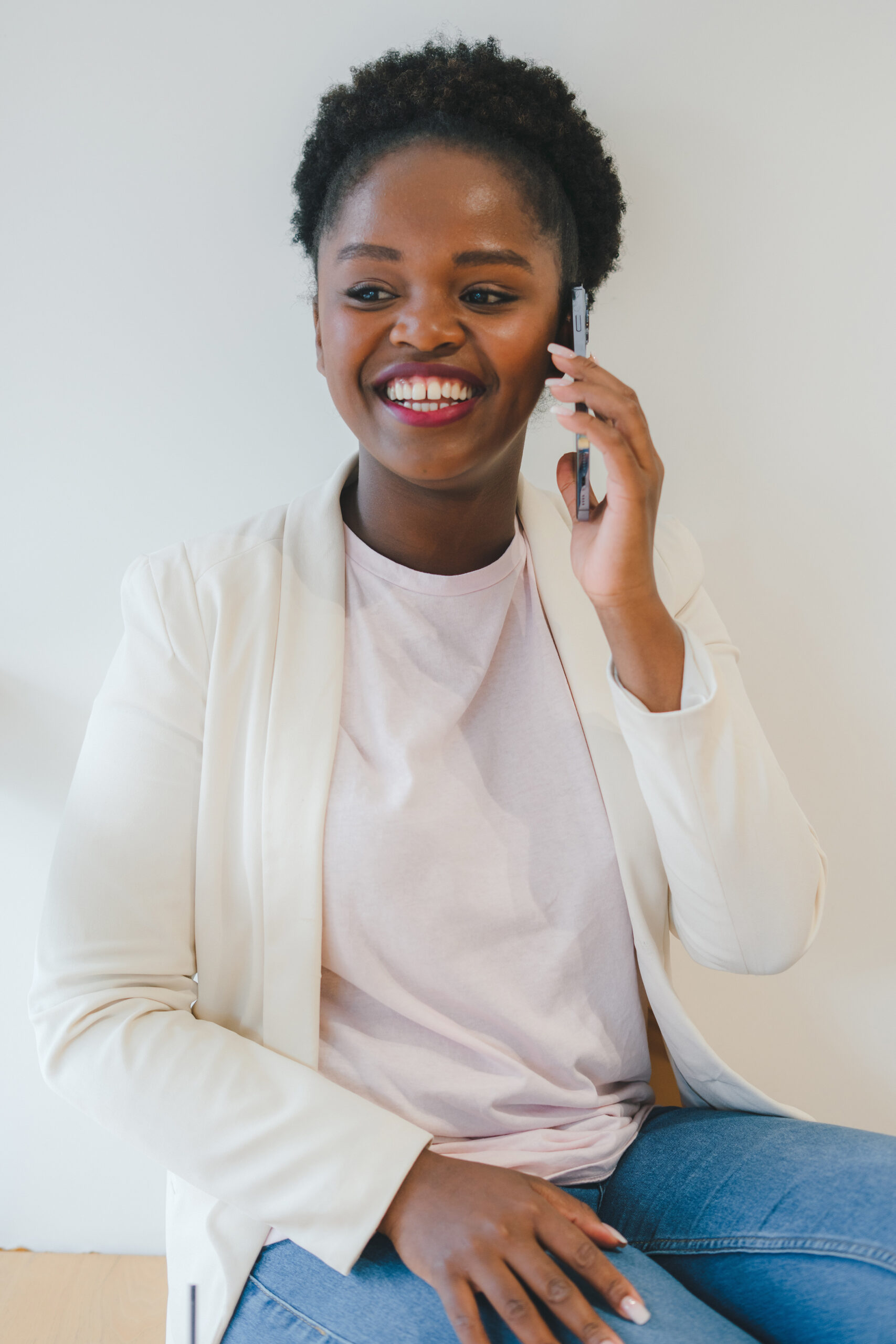 Young Attractive African Woman Talking On Cell Phone To Her Frie