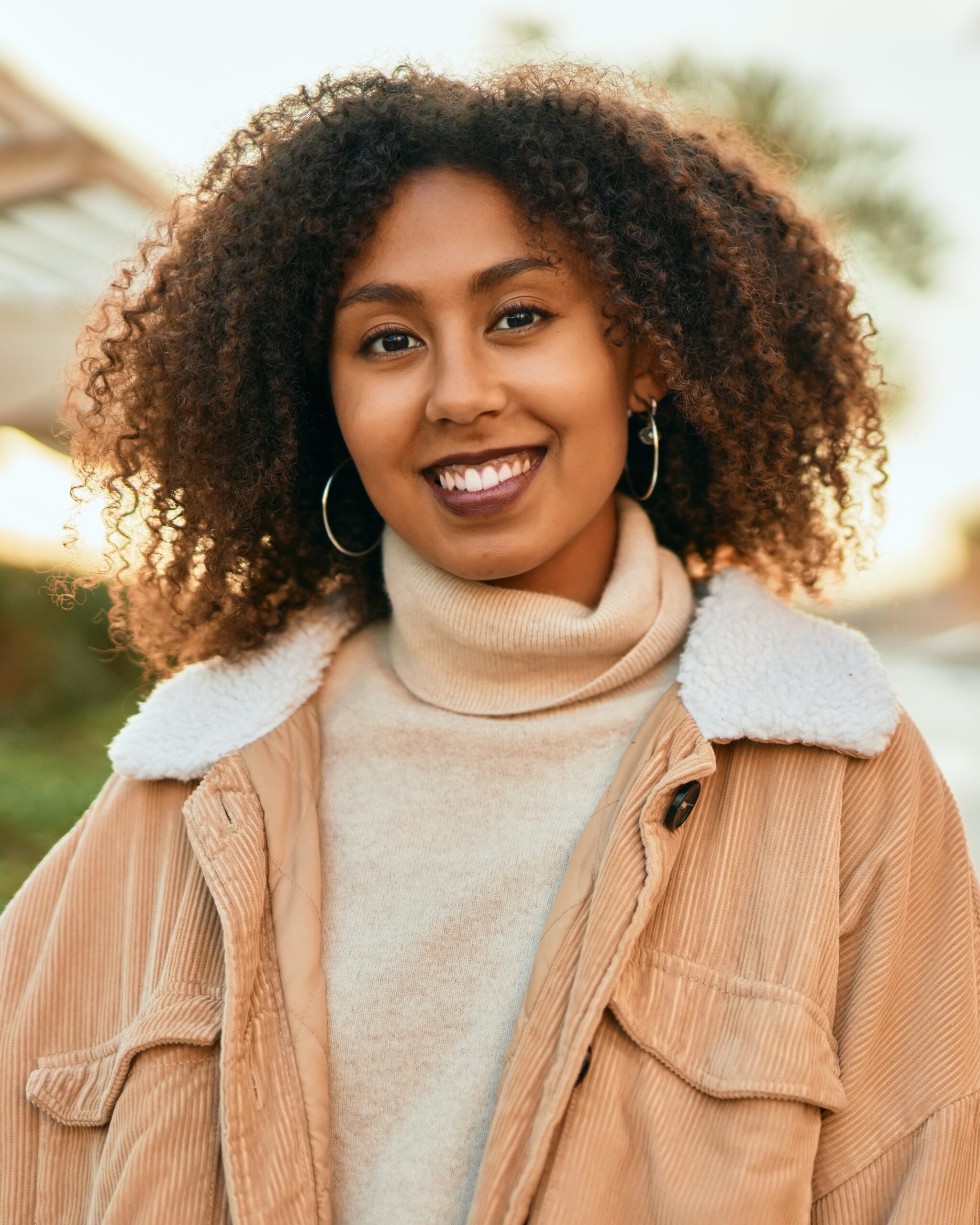 Young african american woman smiling happy standing at the city.