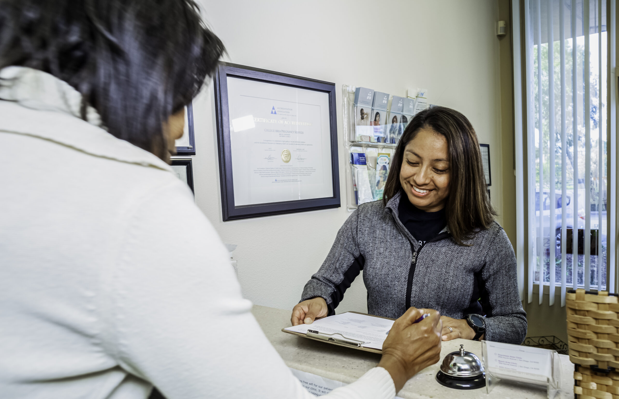 A woman smiling because she just called CAPS and scheduled an appointment to get Abortion Information in California